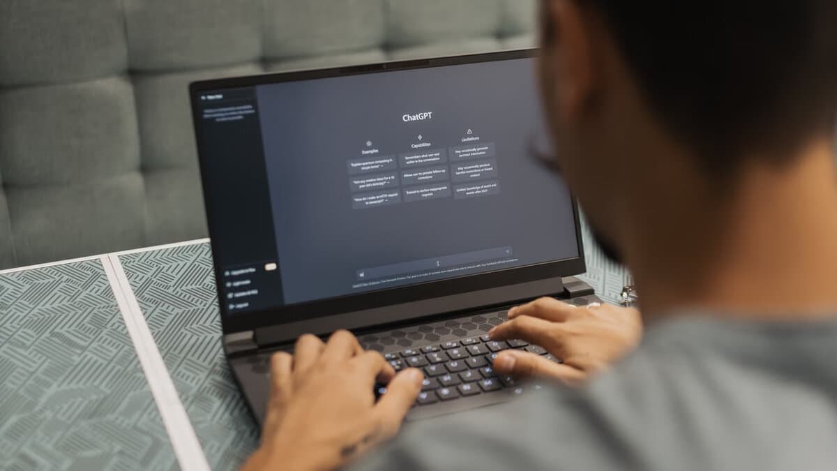 Student tippt am Laptop, auf dem Bildschirm ist die ChatGPT-Oberfläche geöffnet