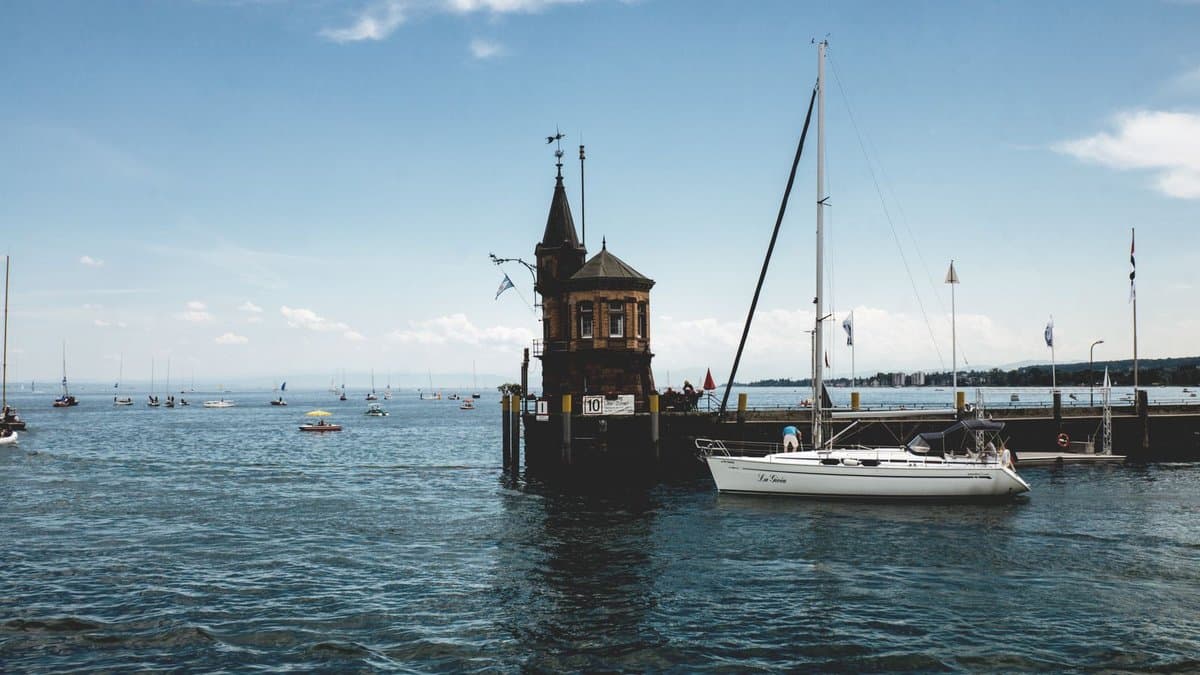 Hafeneinfahrt von Konstanz mit dem historischen Hafenturm und Segelbooten auf dem Bodensee